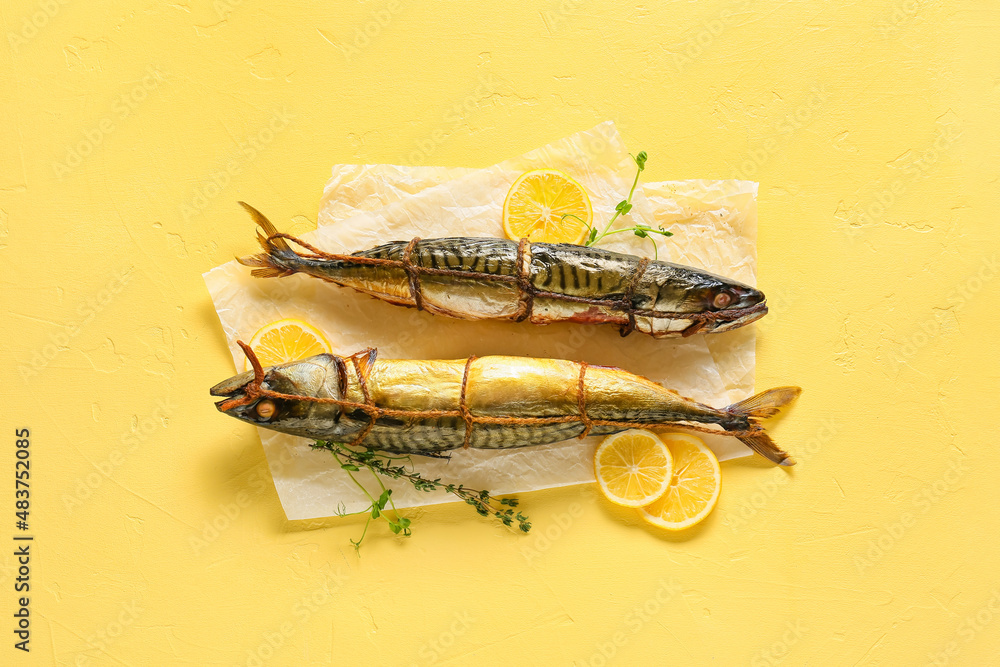 Smoked mackerel fishes on yellow background