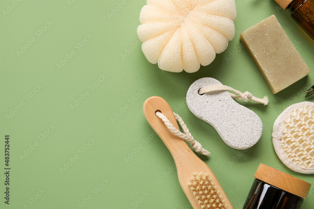 Different bath supplies and cosmetics on green background, closeup