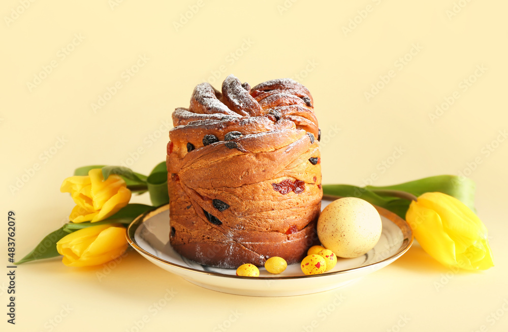 Plate with delicious Easter cake and egg on beige background