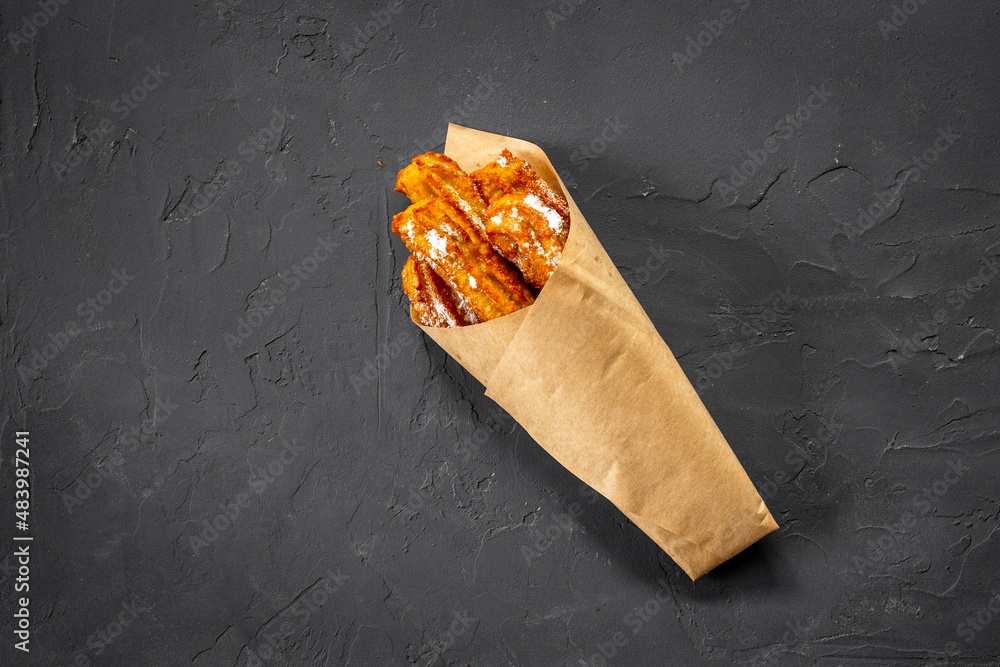 Fast food sweets - churros in paper bag