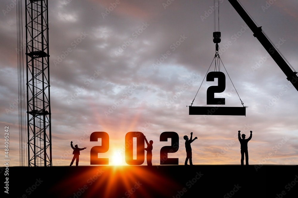 Silhouette of construction worker with crane and sky for preparation of welcome 2022 new year party 