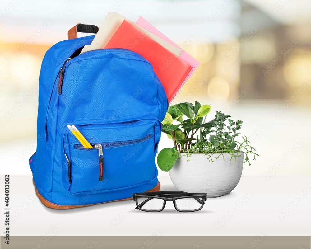 Bright backpack on table home. School supplies. Back to school concept. Educational design objects.