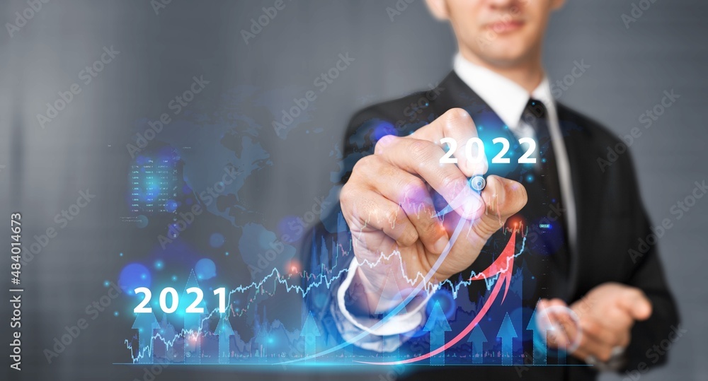 Businessman or trader showing glowing virtual technical investment graph chart for analysis stock ma