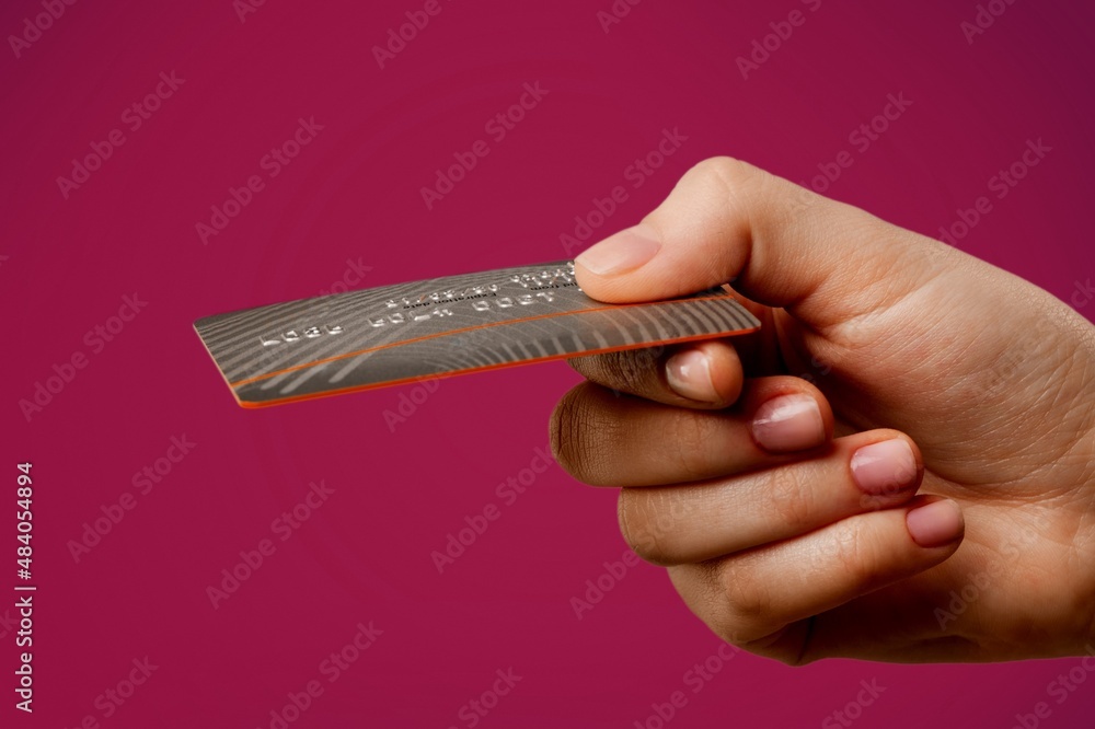 Young female hand and template Bank credit card with online service on background