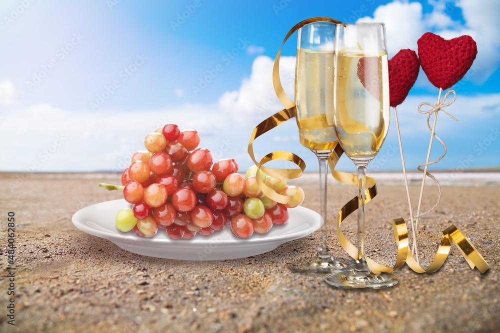 Romantic atmosphere by the sea. Heart between glasses against the background of the sea