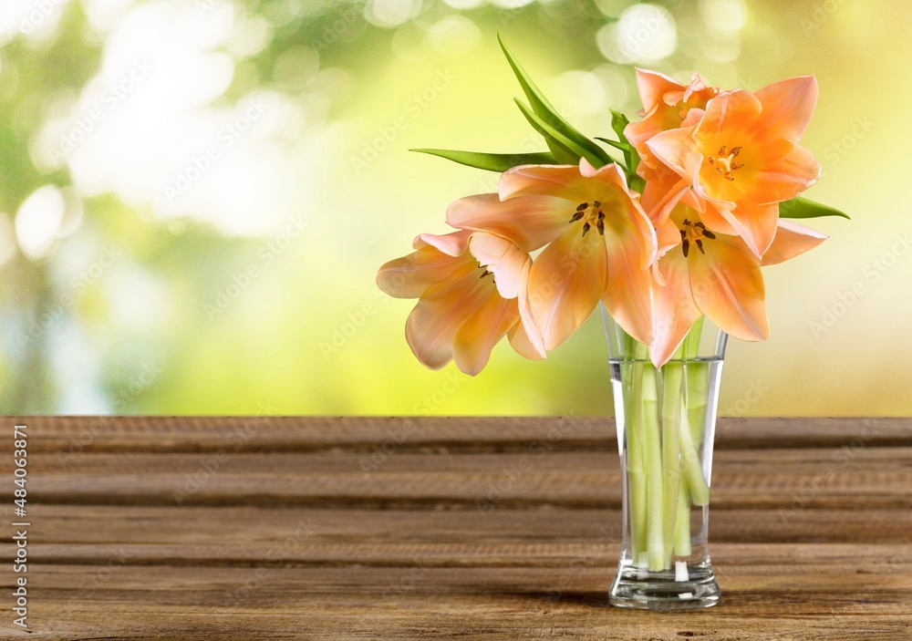 Autumn still life with garden flowers. Beautiful bouquet in a vase on wooden table.