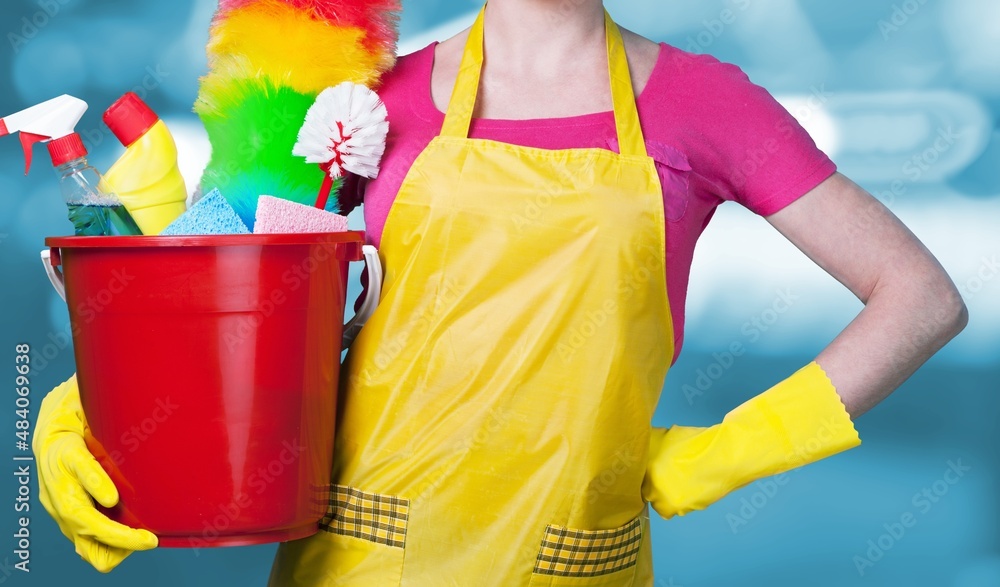 The cleaning lady with many tools on a background