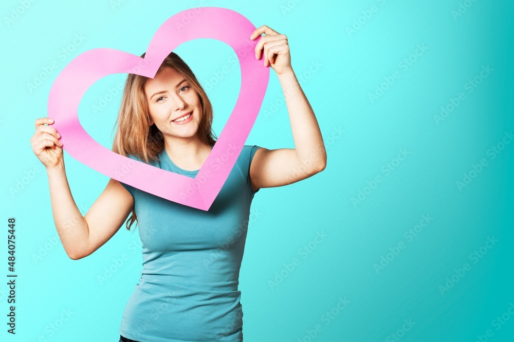 portrait of attractive happy smiling girl with heart, love holiday valentine symbol