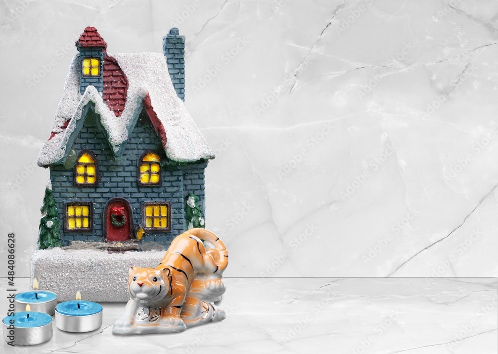 Christmas table decoration with toy house and christmas trees. Festive interior design