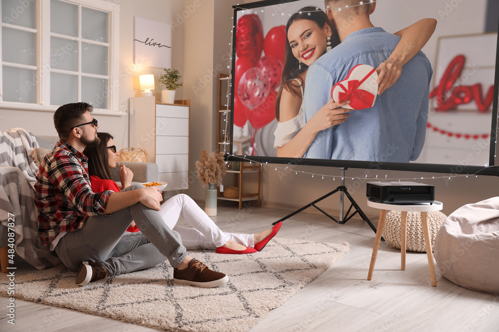 Young couple watching romantic movie at home