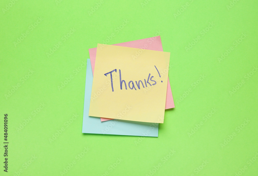 Sticky notes with word THANKS on green background