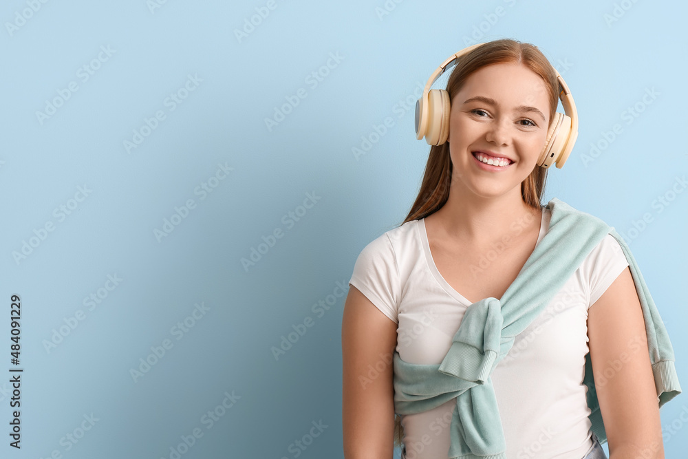 Cool young woman listening to music on color background