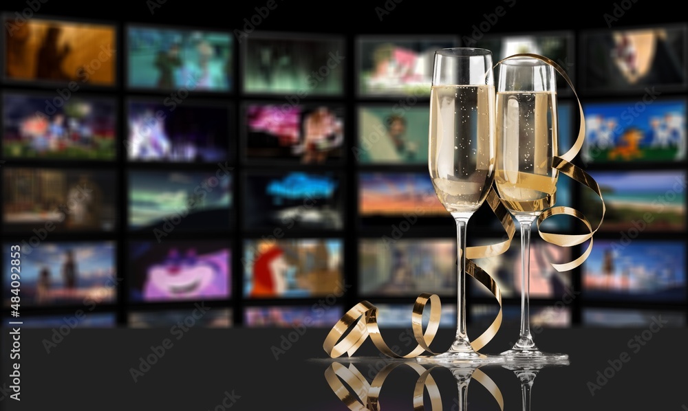 Online TV series and movies for Christmas holidays concept. glass of champagne