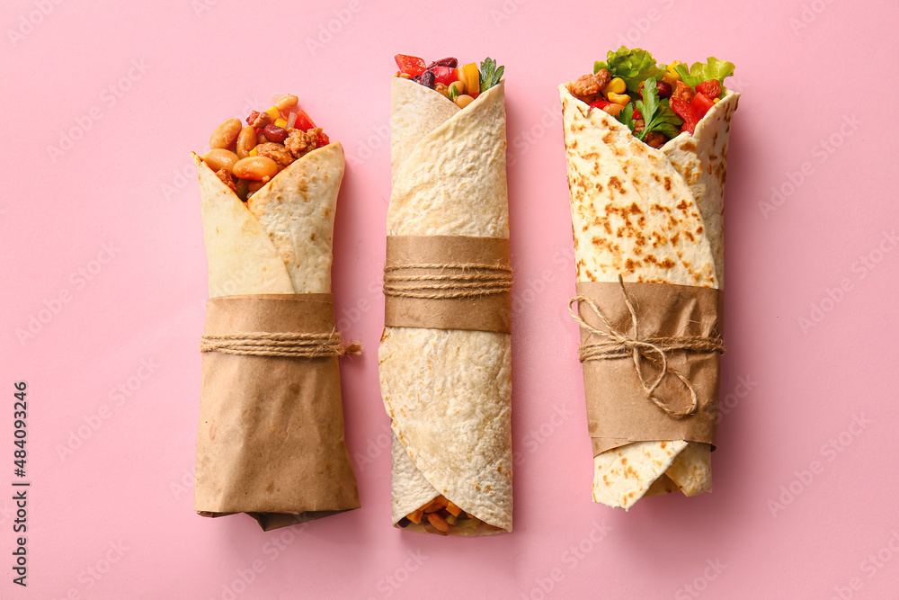 Delicious burritos on pink background