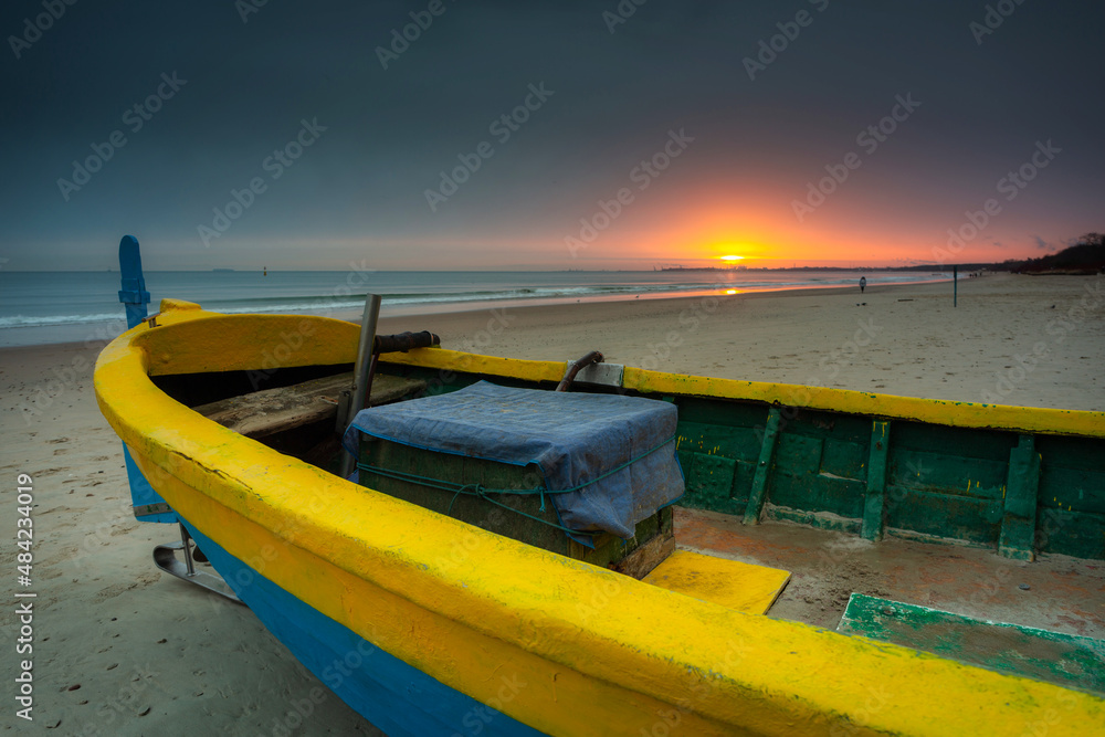 Fishing boat at sunrise on the Baltic Sea beach in Sopot. Poland