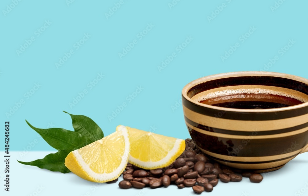 Lemon black coffee in cup, coffee beans, lemon slices