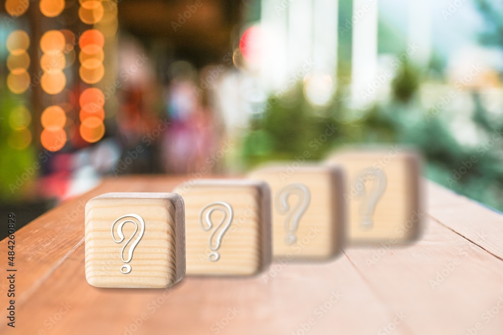 wooden blocks with a question mark. frequently asked questions marketing plan for educational ideas