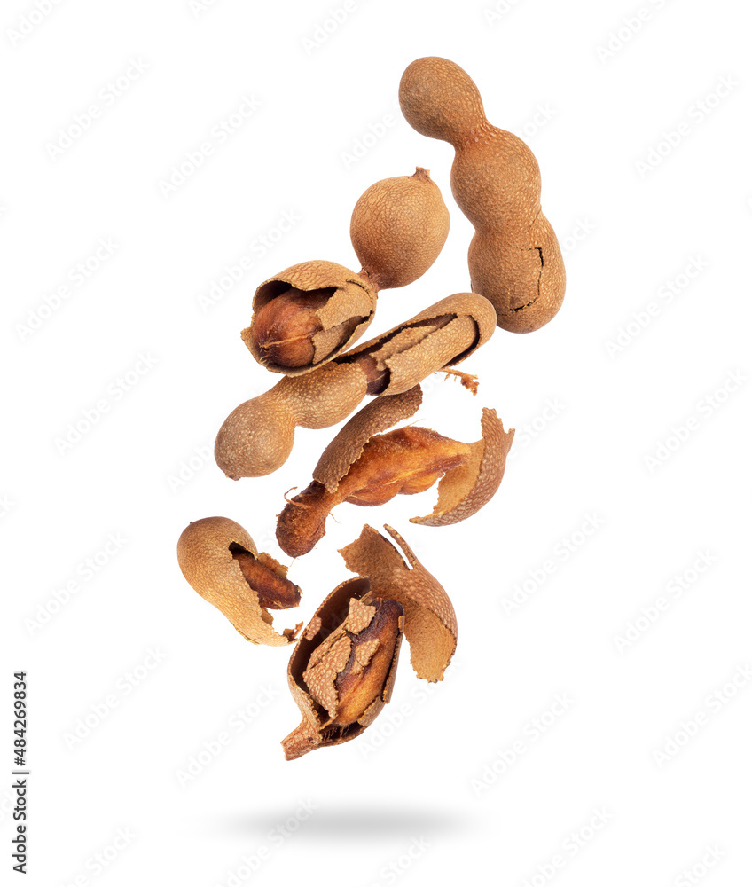 Crushed tamarind fruits in the air isolated on a white background