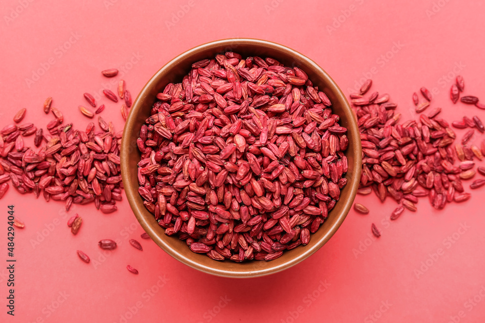 Bowl with dried barberries on red background