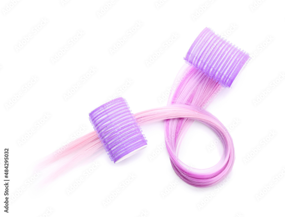 Hair with curlers on light background