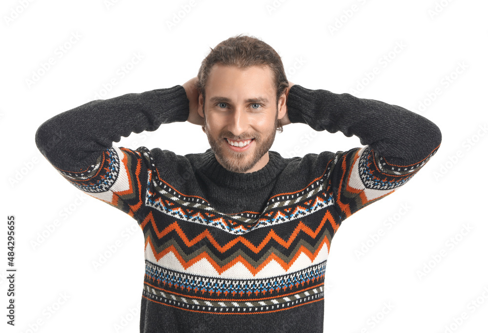 Handsome young man in knitted sweater on white background