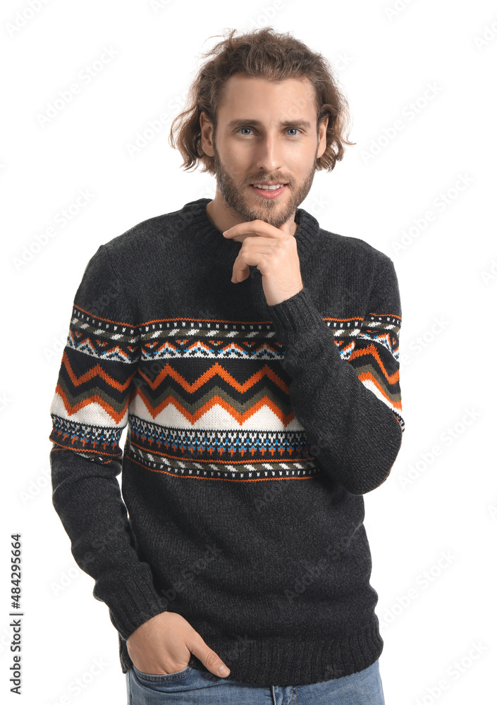 Handsome young man in knitted sweater on white background