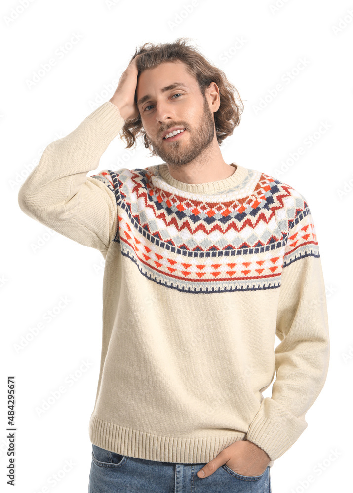 Handsome young man in knitted sweater on white background