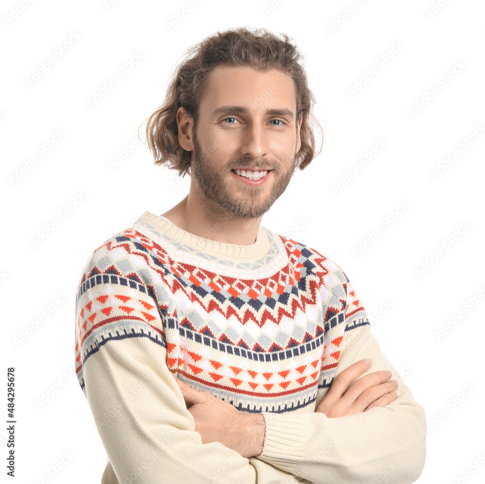 Handsome young man in knitted sweater on white background