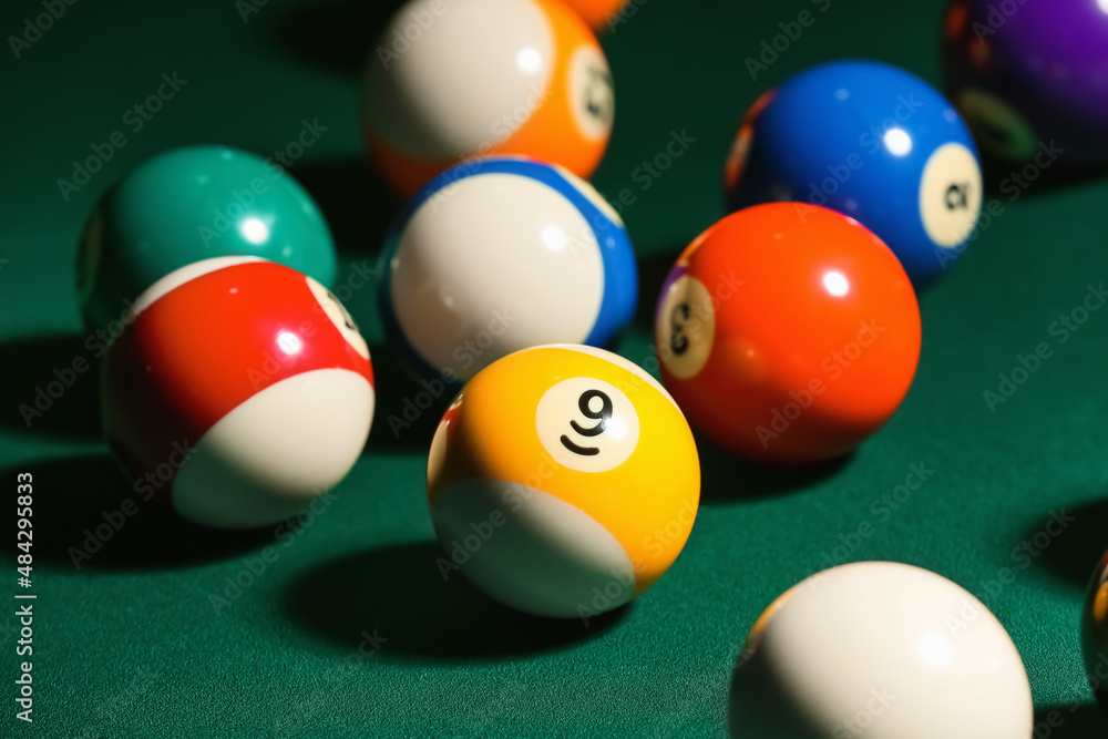 Different billiard balls on green table