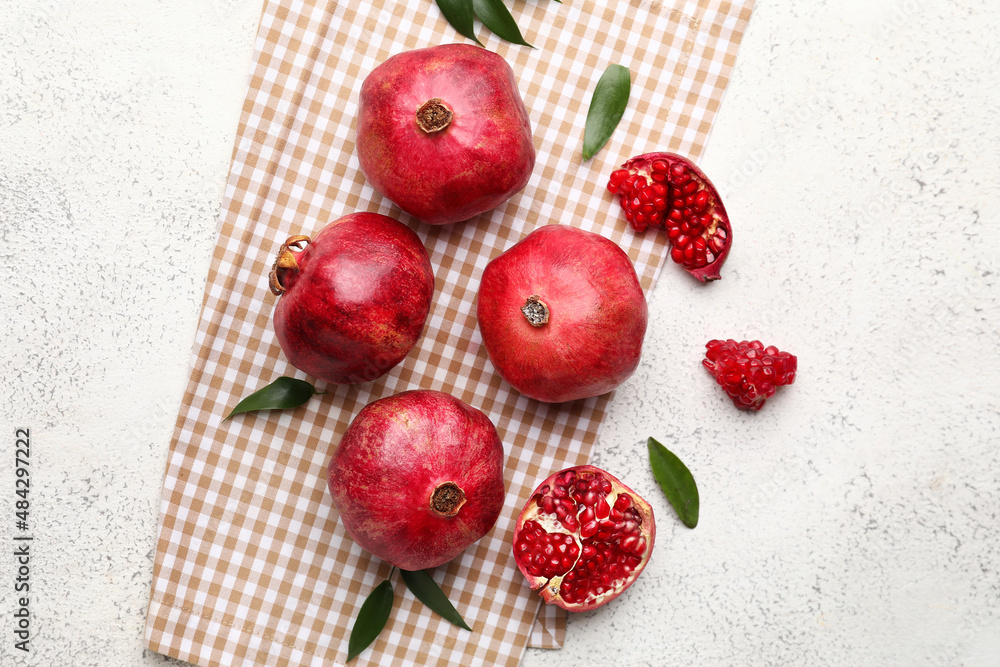 Delicious pomegranates on light background