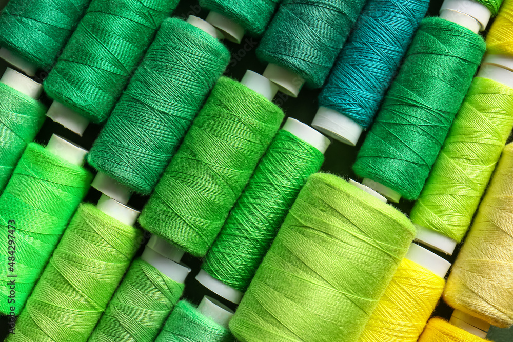 Spools with green threads as background