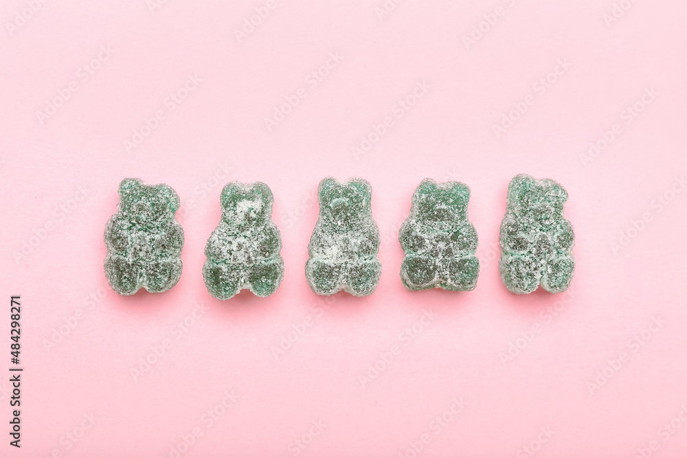 Green jelly bears on color background