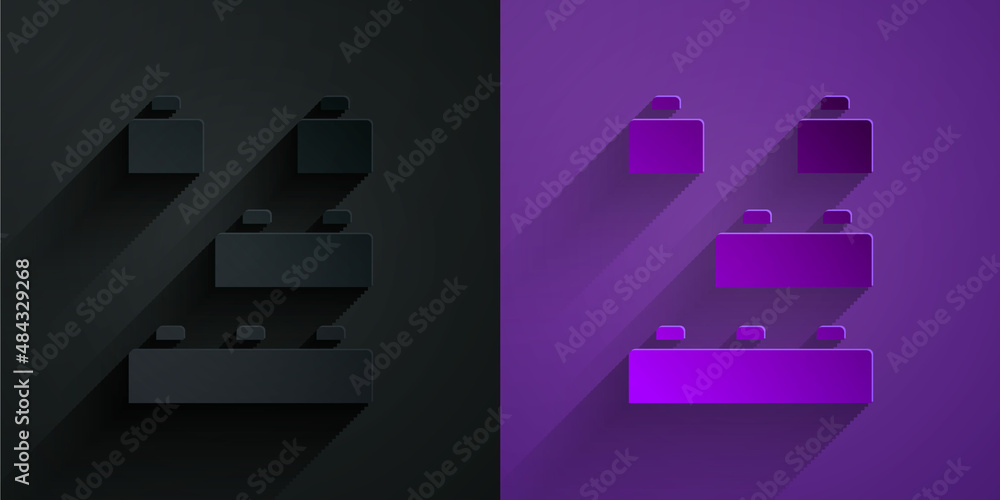 Paper cut Toy building block bricks for children icon isolated on black on purple background. Paper 