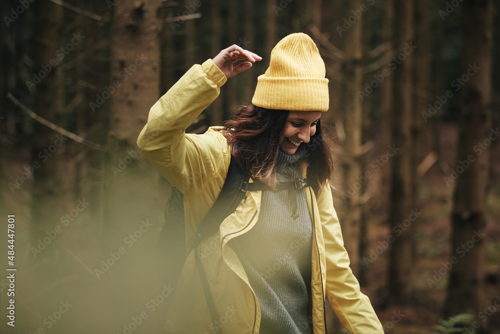 Smiling woman hiking in the woods