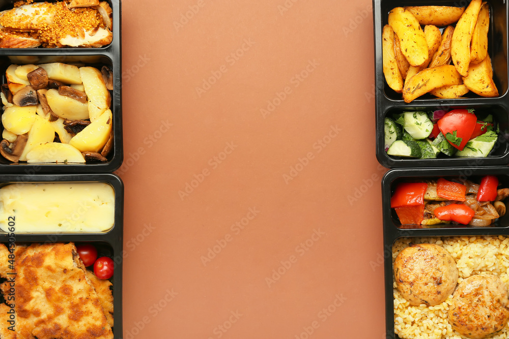 Lunch boxes with tasty meals on color background