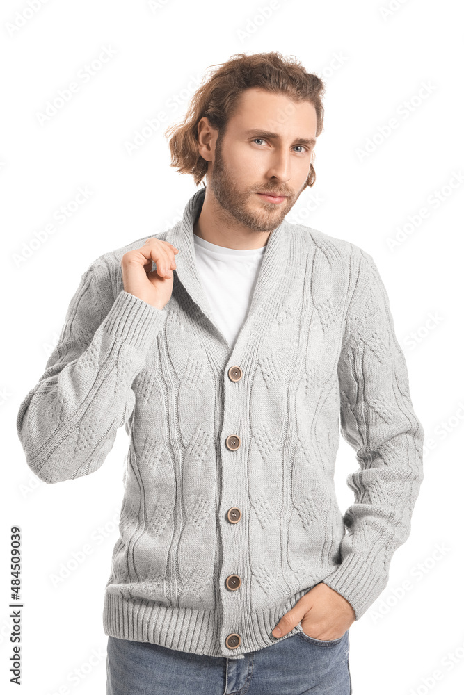 Handsome young man in knitted sweater on white background