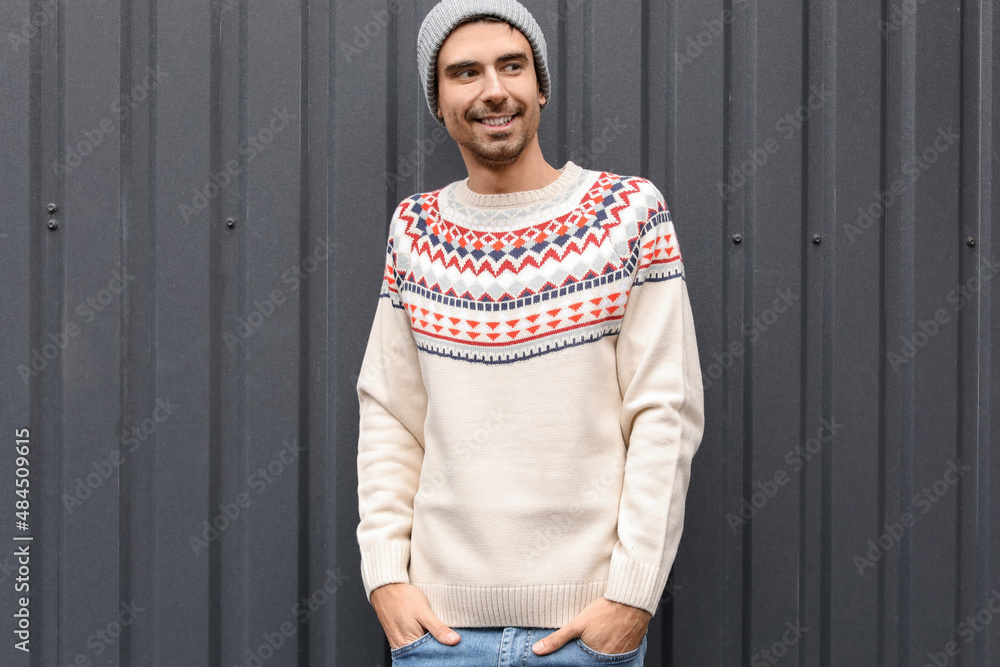 Handsome young man in knitted sweater outdoors