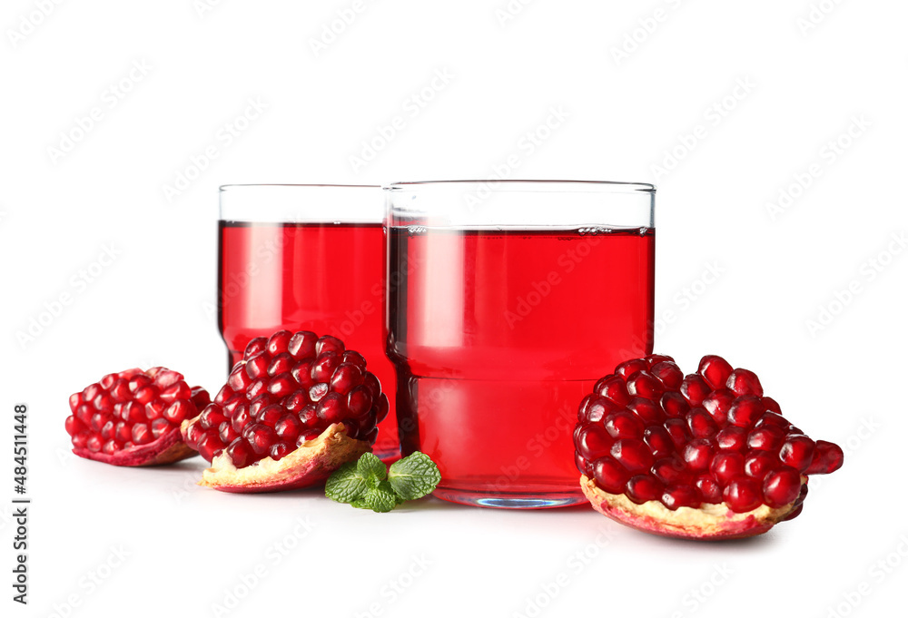 Glasses of delicious pomegranate juice on white background