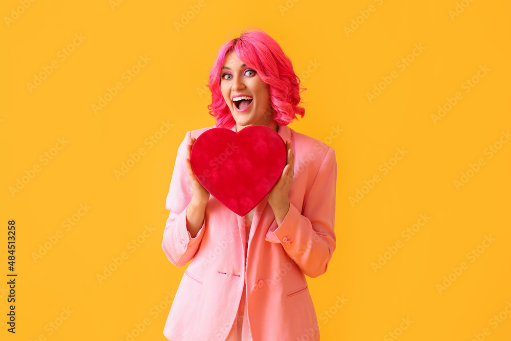 Happy woman with bright hair and gift on color background. Valentines Day celebration