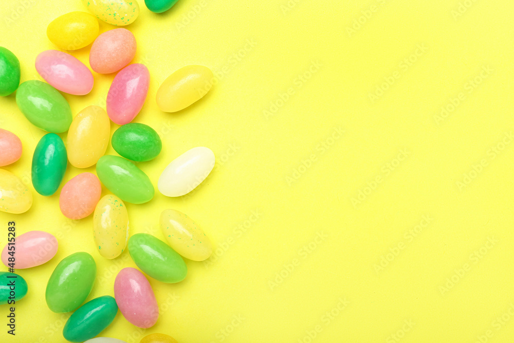 Multicolored jelly beans on color background