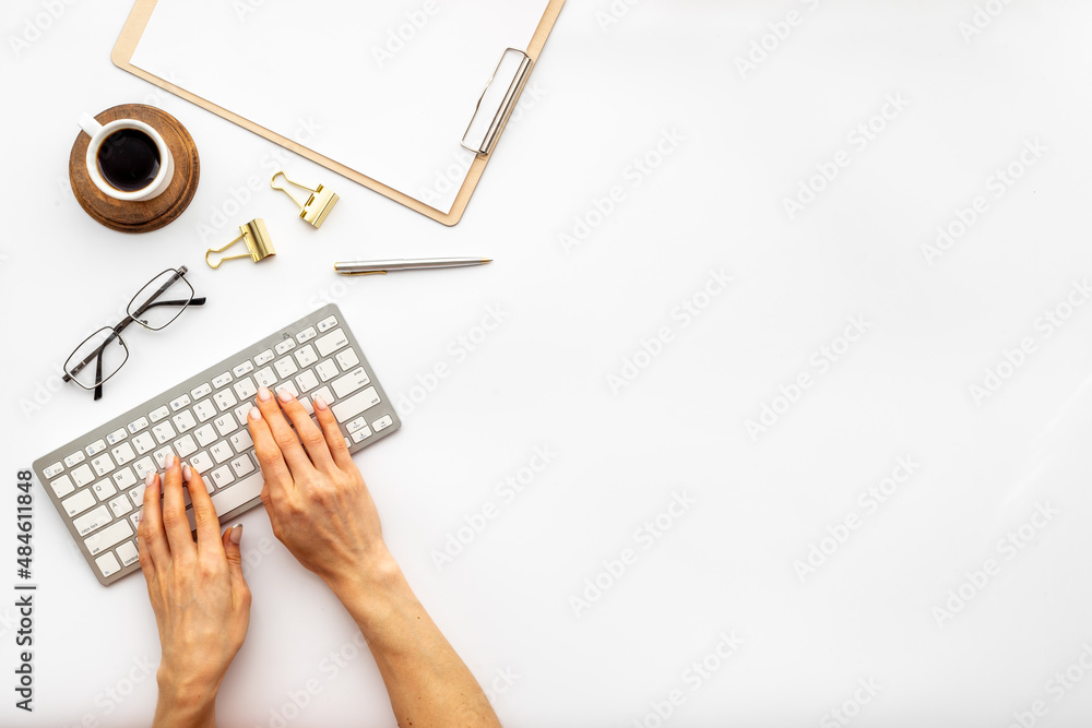 Hands working on the office table with computer, top view