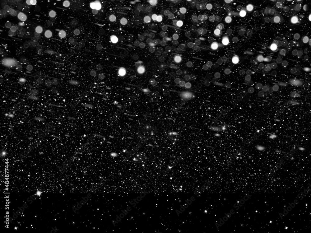 Best photo of falling medium sized snowflakes out of focus on black background