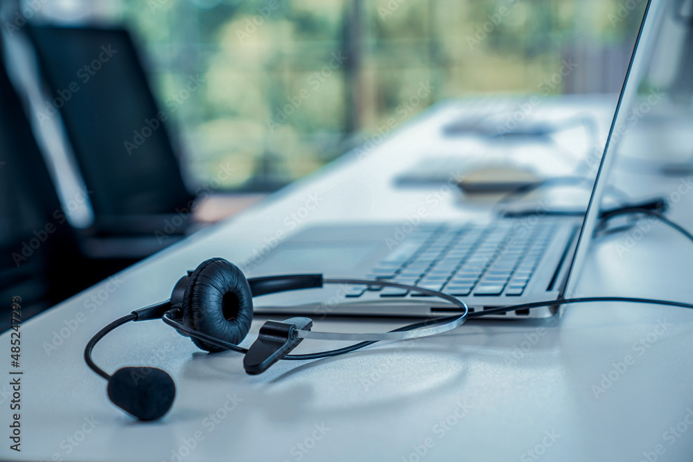 Headset and customer support equipment at call center ready for actively service . Corporate busines