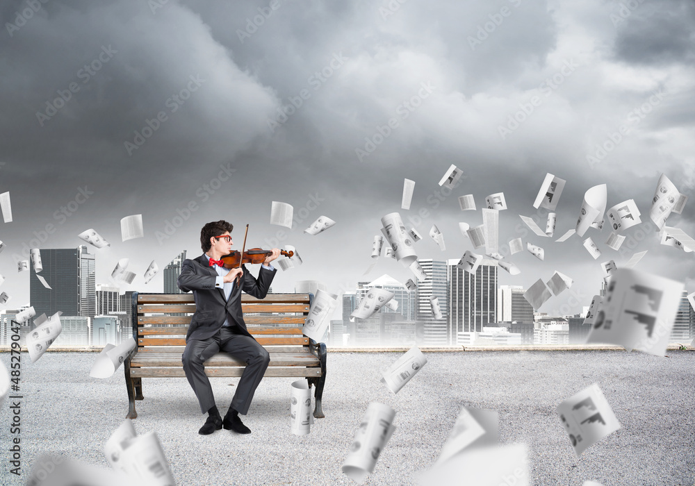 Young businessman plays the violin