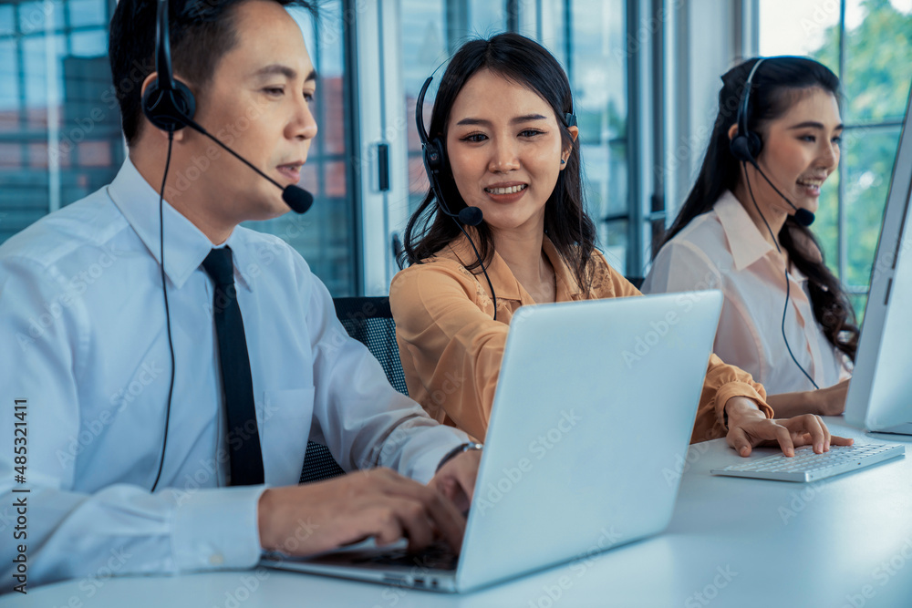 Business people wearing headset working actively in office . Call center, telemarketing, customer su