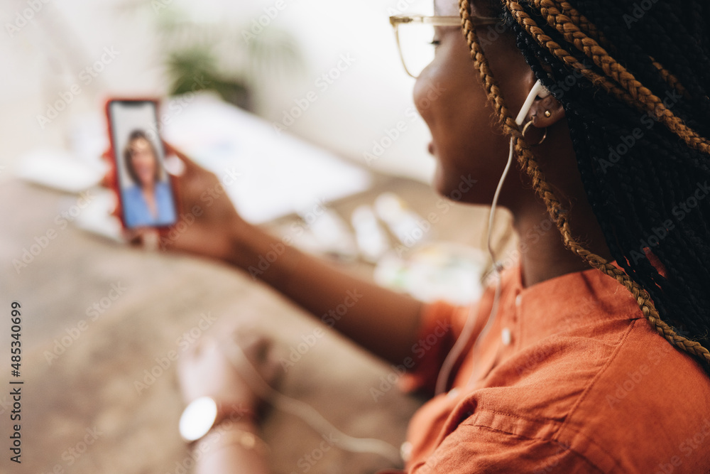 Creative freelancer taking a video call at her desk