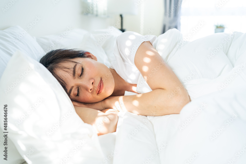 Asian beautiful comfort girl in pajamas get up from sleep in bedroom. 