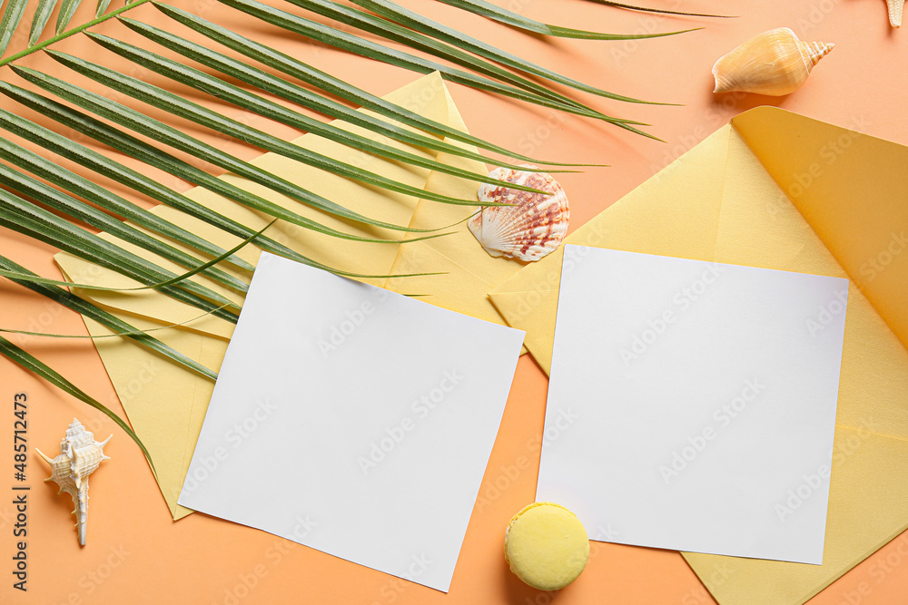 Composition with blank cards, palm leaf and seashells on color background