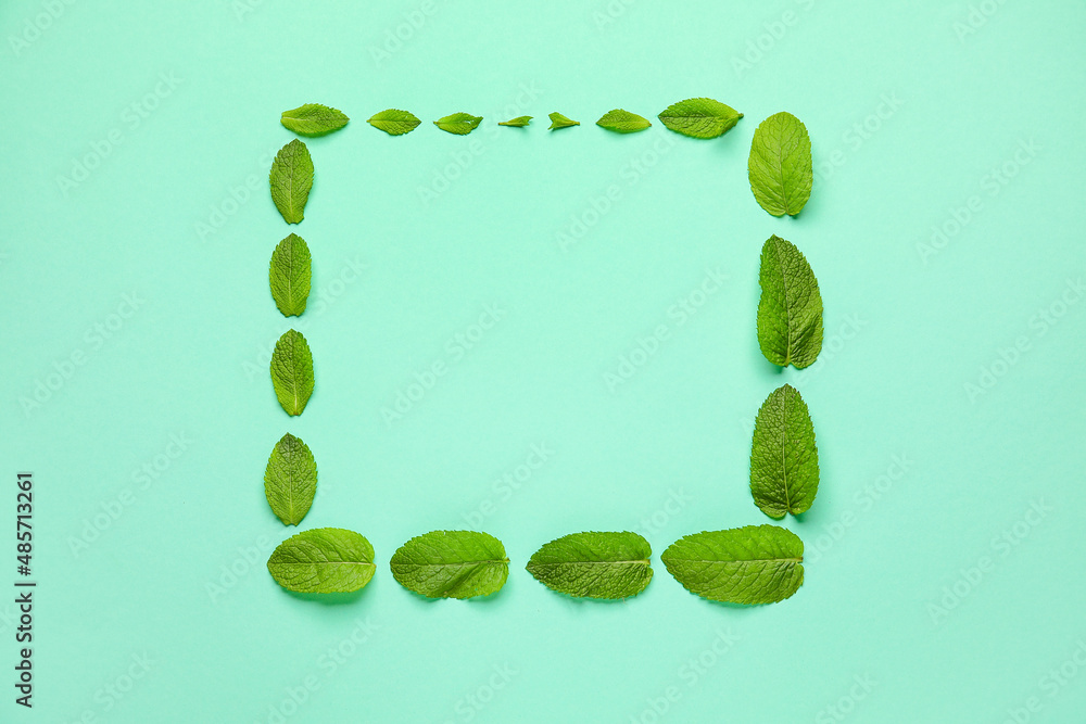 Frame made of fresh mint leaves on color background