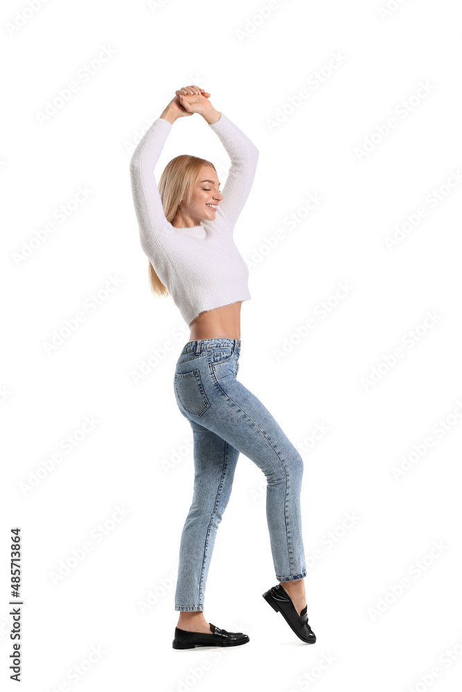 Fashionable young woman in stylish jeans on white background